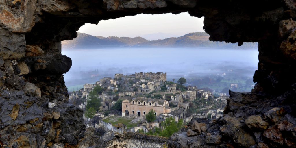 Historical stone ruins of Levissi Kayakoy on the hillside
