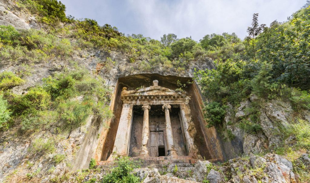 The grand façade of the Tomb of Amyntas with its massive Ionic columns in Fethiye
