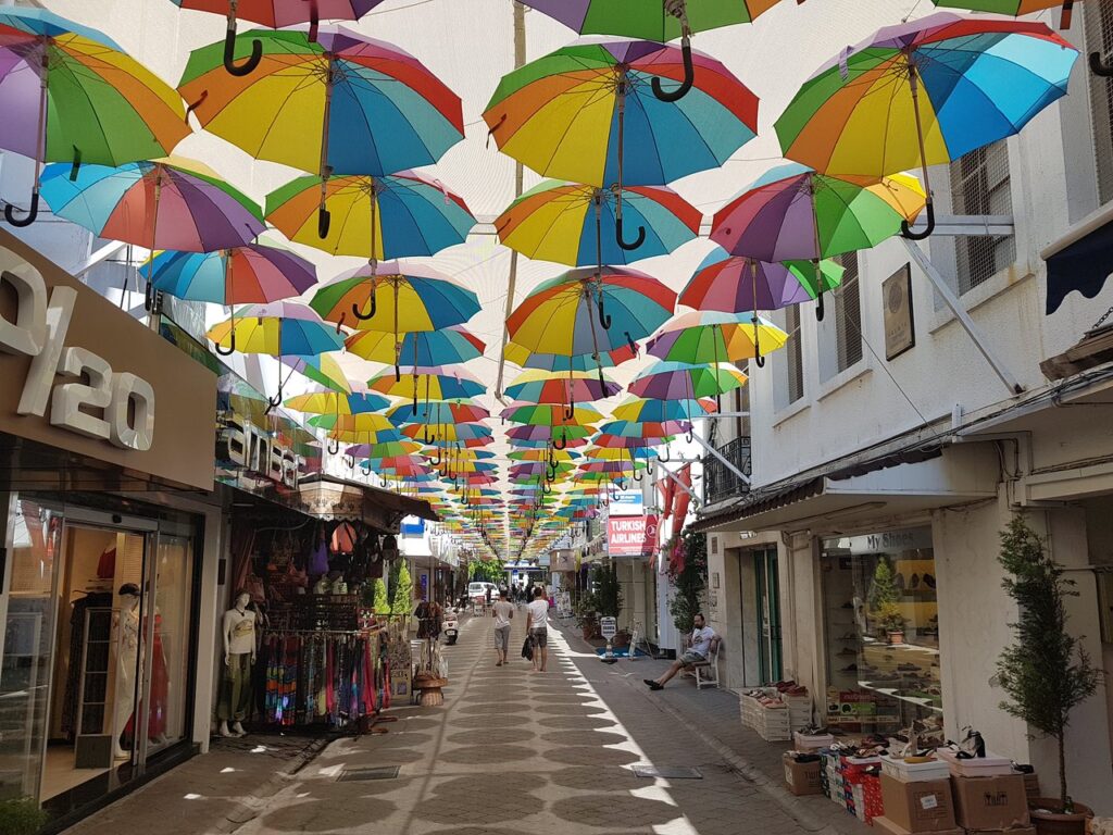 Street scene in Paspatur Old Town, Fethiye, with colourful umbrellas overhead