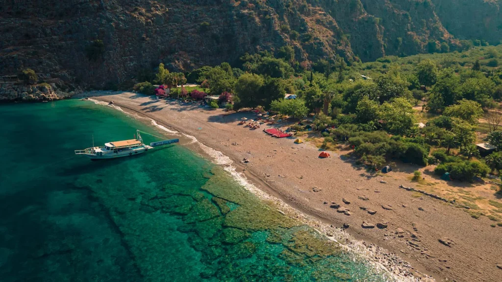 Pebble beach and limestone cliffs at Butterfly Valley near Ölüdeniz