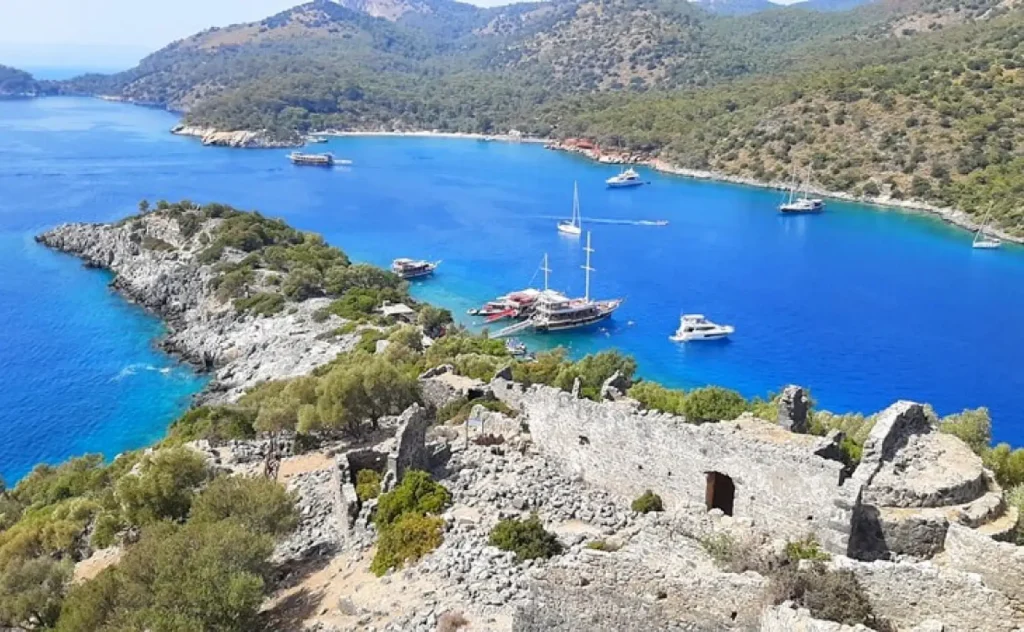 Aerial view of St. Nicholas Island (Gemiler Island) near Oludeniz, showing Byzantine church ruins and turquoise Mediterranean waters.