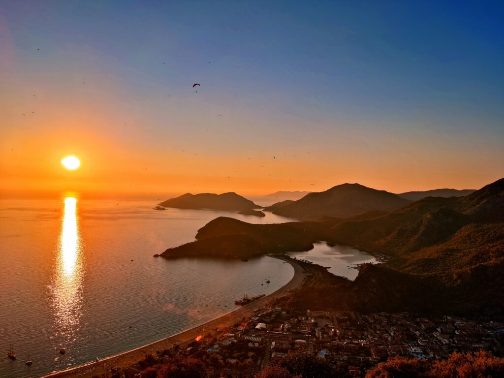 Ölüdeniz & Blue Lagoon Guide 2026: Beach Tips & Transport 3 Sunset view over Ölüdeniz and the surrounding coastline